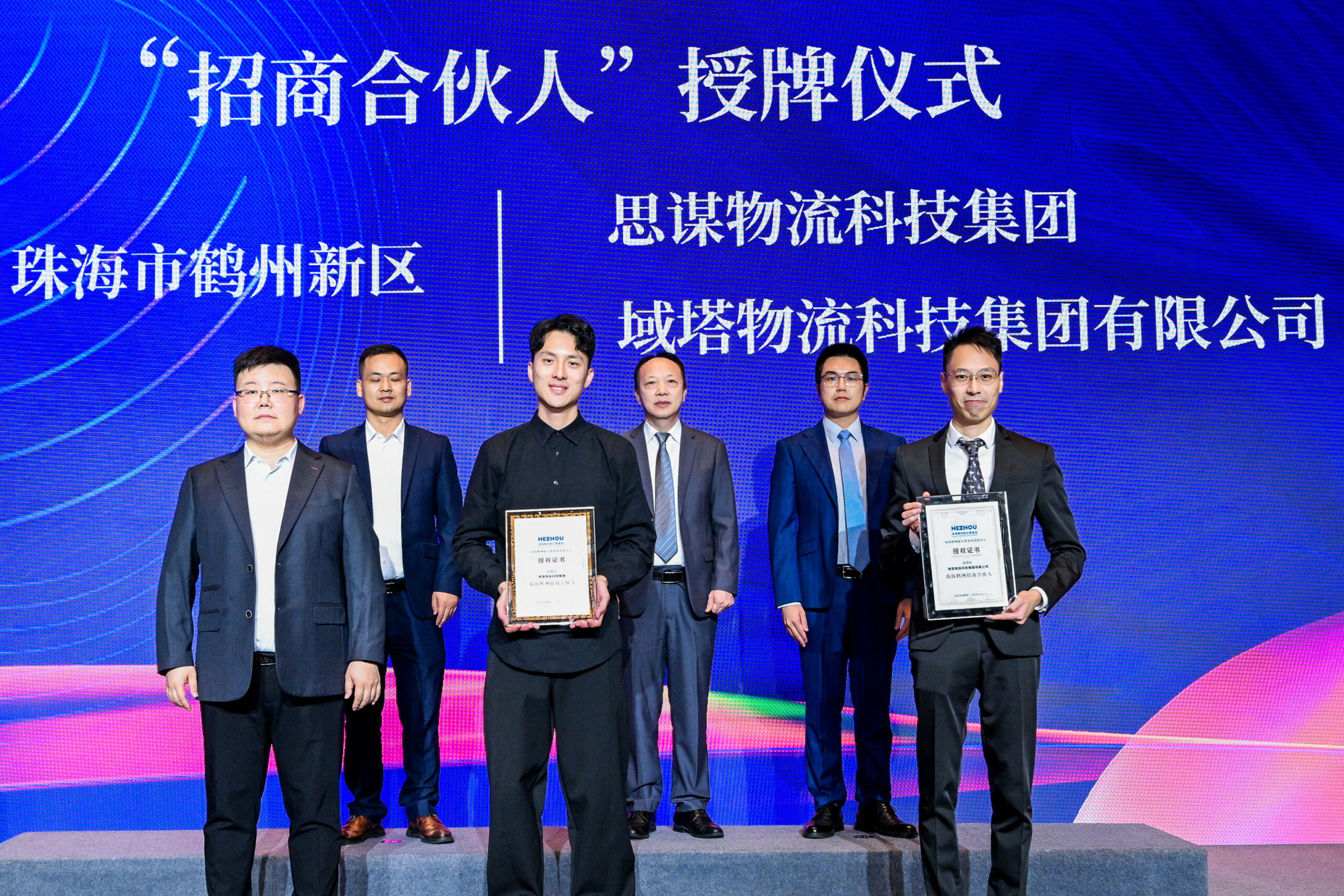 鹤州新区向域塔物流科技集团（右）和思谋物流科技集团（中）颁授「招商合伙人」证书。